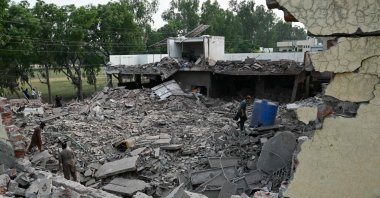 Locals stand on the debris of destroyed structures at the Government Health and Educational complex, Muridke, near Lahore, Pakistan, May 7, 2025. (AFP Photo)