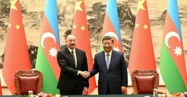 Azerbaijani President Ilham Aliyev (L) and Chinese President Xi Jinping shake hands during a signing ceremony at the Great Hall of the People, Beijing, China, April 23, 2025. (DHA Photo)