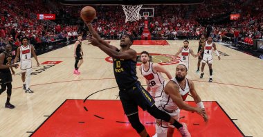 Golden State Warriors' Jimmy Butler III (L) goes up for a lay-up against Houston Rockets' Dillon Brooks in the second half in Game 7 of the Western Conference First Round NBA Playoffs at Toyota Center, Houston, U.S., May 4, 2025. (AFP Photo)