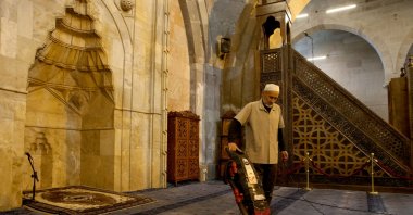 Turgut Ince, 61, cleans the historic Ulu Cami, ensuring its readiness for prayers, Kayseri, Türkiye, May 6, 2025. (AA Photo)