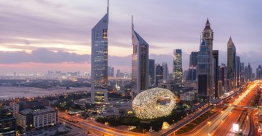 The Museum of the Future is backdropped by the Dubai skyline at sunrise, Dubai, UAE. (Shutterstock Photo)