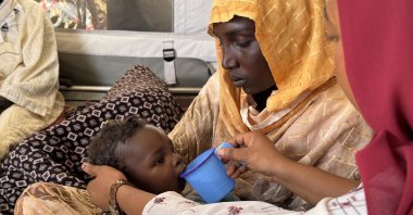 A child is provided with water by an MSF nurse, in Tawila Umda health post, North Darfur, Sudan, April 20, 2025. (Photo courtesy: MSF)