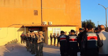 Gendarmerie forces bring arrested suspects to the Gendarmerie building following an organized crime operation, Çanakkale, Türkiye, May 3, 2025. (IHA Photo) 









