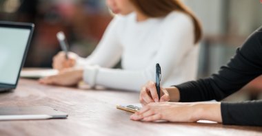 An international student takes an exam in a university classroom. (Shutterstock Photo)