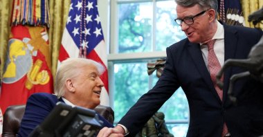 U.S. President Donald Trump (L) shakes hands with Britain&#039;s ambassador to the U.S., Peter Mandelson, after announcing a trade deal with the U.K., Washington, D.C., U.S., May 8, 2025. (Reuters Photo)