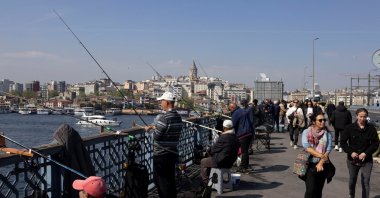 People fish from the Galata Bridge in Istanbul, Türkiye, April 25, 2025. (Reuters Photo)