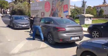 In this handout photo from security sources, police detain one of the suspects at his rental vehicle during the operation in Istanbul, Türkiye. (AA Photo)