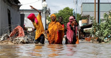 A Somali family wades through flood waters, as they flee after overnight rains destroyed their home, in Wadajir district, Mogadishu, Somalia, May 10, 2025. (Reuters Photo)