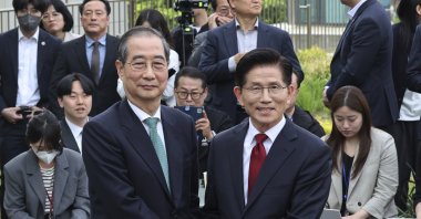South Korea&#039;s People Power Party&#039;s presidential election candidate Kim Moon Soo (R) and independent preliminary presidential election candidate Han Duck-soo pose for a photo during a meeting, Seoul, South Korea, May 8, 2025. (AP Photo)