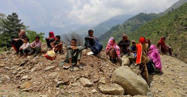 People evacuated from their homes near the Line of Control (LoC) between India and Pakistan following cross-border shelling, wait as authorities stopped them from returning to their villages, Gantamulla, India-ruled Kashmir, May 11, 2025. (Reuters Photo)