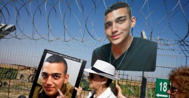 Varda Ben Baruch, grandmother of hostage Edan Alexander, points at his portrait at Kibbutz Nir Oz, Israel, April 20, 2025. (Reuters Photo)