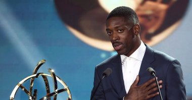 Paris Saint-Germain&#039;s Ousmane Dembele (L) reacts after receiving the French Ligue 1 Best Football Player award during the televised UNFP (French National Professional Football players Union) trophy ceremony, Paris, France, May 11, 2025. (AFP Photo)