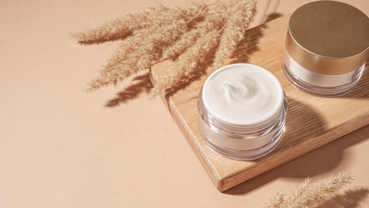 Jars of cosmetic cream with pampas grass. (Shutterstock Photo)