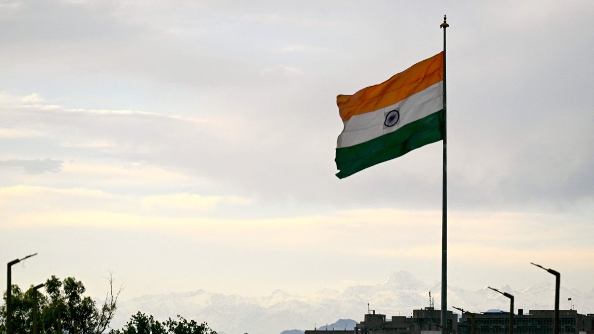 Snow-capped slopes of Trikuta hills are pictured behind India&#039;s national flag in Jammu, India-ruled Jammu and Kashmir, May 11, 2025. (AFP Photo)