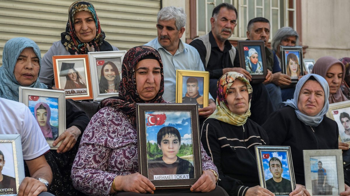 Families hold photographs of their children abducted by the PKK, Diyarbakır, southeastern Türkiye, May 12, 2025. (AFP Photo)