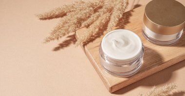 Jars of cosmetic cream with pampas grass. (Shutterstock Photo)