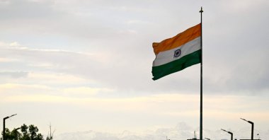 Snow-capped slopes of Trikuta hills are pictured behind India&#039;s national flag in Jammu, India-ruled Jammu and Kashmir, May 11, 2025. (AFP Photo)