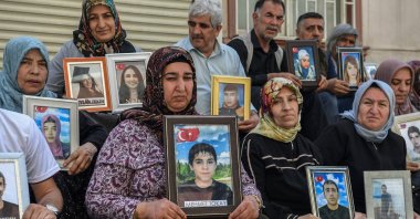 Families hold photographs of their children abducted by the PKK, Diyarbakır, southeastern Türkiye, May 12, 2025. (AFP Photo)