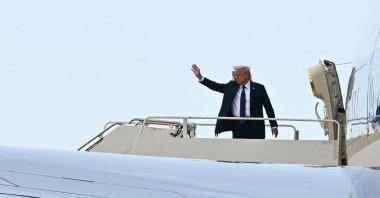 U.S. President Donald Trump waves as he boards an Air Force One in Fiumicino, Italy, April 26, 2025. (AFP Photo)