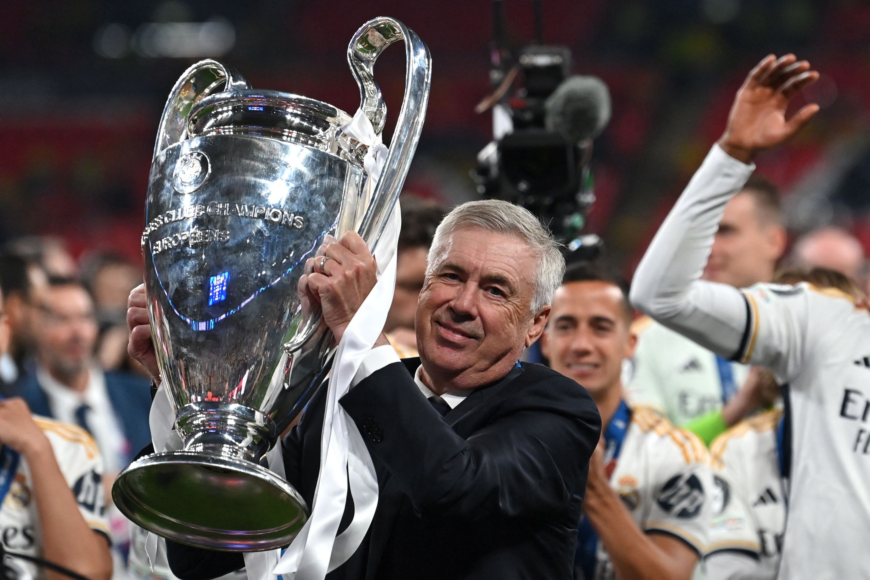 Real Madrid's coach Carlo Ancelotti lifts the trophy to celebrate the victory at the end of the UEFA Champions League final match between Borussia Dortmund and Real Madrid, London, U.K., June 1, 2024. (AFP Photo)