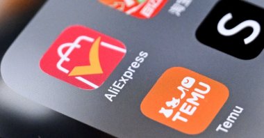 An illustration photo shows the logos of Chinese shopping apps Taobao (top), AliExpress (L), Shein app (R) and online marketplace Temu on a smartphone screen, Frankfurt, Germany, April 24, 2025. (AFP Photo)