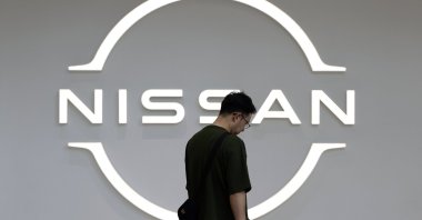 A visitor walks past the logo of Nissan Motor at the carmaker&#039;s headquarters&#039; showroom in Yokohama, Japan, May 13, 2025. (EPA Photo)