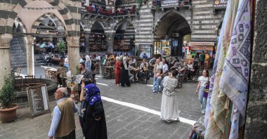 People sit in traditional Turkish tea houses near the Great Mosque of Diyarbakır (Ulu Camii) in the historical Sur district after the announcement of the PKK&#039;s dissolution, Diyarbakır, southeastern Türkiye, May 12, 2025. (AFP Photo)