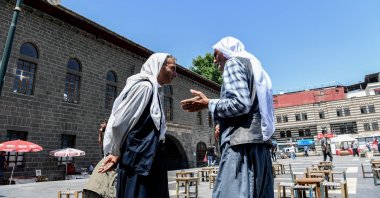 Two men chat in the courtyard of the Great Mosque of Diyarbakır (Ulu Camii) in the historical Sur district after the announcement of the PKK&#039;s dissolution, Diyarbakır, southeastern Türkiye, May 12, 2025. (AFP Photo)