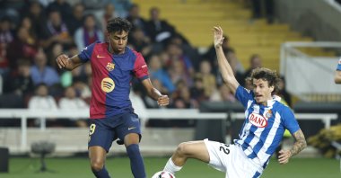 Barcelona's Lamine Yamal (L) challenges for the ball with Espanyol's Carlos Romero during a La Liga match at the Lluis Companys Olympic Stadium, Barcelona, Spain, Nov. 3, 2024. (AP Photo)