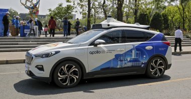 A Baidu Apollo Robotaxi passes its customer service counter setup at the Shougang Park, Beijing, China, May 2, 2021. (AP photo)