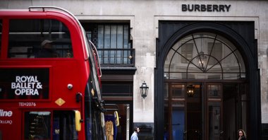 Pedestrians walk past a double-decker bus and the store of British fashion label Burberry, in central London, U.K., Sept. 2, 2024. (AFP Photo)
