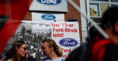 The word &quot;Strike&quot; is displayed in the typography of the Ford sign on a banner, as workers rally during a strike by the IG Metall union at a Ford plant, Cologne, Germany, May 14, 2025. (Reuters Photo)