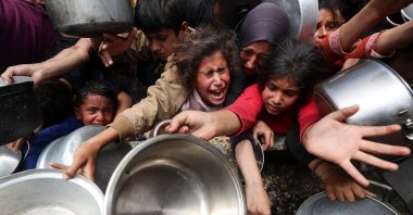 Palestinians wait to receive food at a charity kitchen, in Jabalia, northern Gaza Strip, Palestine, May 14, 2025. (Retuers Photo)
