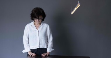 Iranian filmmaker and activist Sepideh Farsi looks at a portrait of the Palestinian photographer Fatima Hassouna, during a photo session at her home, Paris, France, May 5, 2025. (AFP Photo)