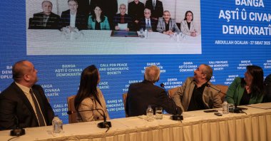The Imralı delegation looks at a photo taken with PKK leader Abdullah Öcalan, during a news conference in Istanbul, Türkiye, Feb. 27, 2025 (Reuters Photo)