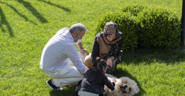 Sinem Şahinler and her husband play with a child at a children’s home, reflecting the warmth and dedication they offer orphans through the Hope House Istanbul Association, Istanbul, Türkiye, May 7, 2025. (AA Photo)