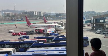A boy looks at Air India airline passenger aircraft parked at Chhatrapati Shivaji Maharaj International Airport, Mumbai, India, Feb. 1, 2024. (Reuters Photo)