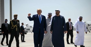 U.S. President Donald Trump (L), accompanied by his UAE counterpart Sheikh Mohammed bin Zayed Al Nahyan, gestures with a clenched fist as he prepares to board Air Force One in Abu Dhabi, United Arab Emirates, at the end of his Middle East tour, May 16, 2025. (AFP Photo)