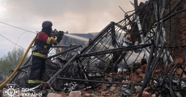 This handout photograph taken and released by the Ukrainian State Emergency Service shows a firefighter extinguishing the fire in a building following an air-attack amid the Russian invasion of Ukraine, in Sumy, northeastern Ukraine, May 6, 2025. (AFP Photo)
