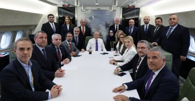 In this handout photo from the Turkish Presidency, President Recep Tayyip Erdoğan (C) poses with a group of journalists during an interview on his return flight from Albania on the presidential plane, May 16, 2025. (AA Photo)