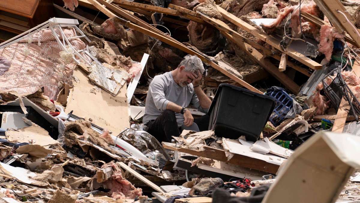 James Sexton is overcome by emotions while cleaning up the debris of his house in the community of Sunshine Hills outside of London, Kentucky, U.S., May 18, 2025. (AFP Photo)