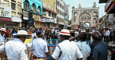 Rescue workers and police stand outside the building that caught fire in Hyderabad, India, May 18, 2025. (AFP Photo)