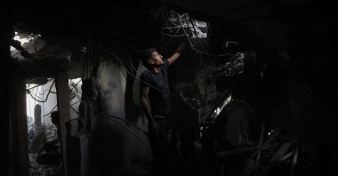 A Palestinian man searches the rubble of a house hit in Israeli strikes in the al-Saftawi area, northern Gaza Strip, Palestine, May 18, 2025. (AFP Photo)