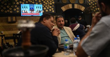Syrians watch a speech by Syrian President Ahmad al-Sharaa at a cafe in central Damascus, Syria, May 14, 2025. (EPA Photo)