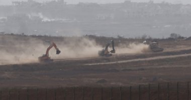 An Israeli military vehicle and excavators manoeuvre inside the Gaza Strip, Palestine, May 18, 2025. (Reuters Photo)