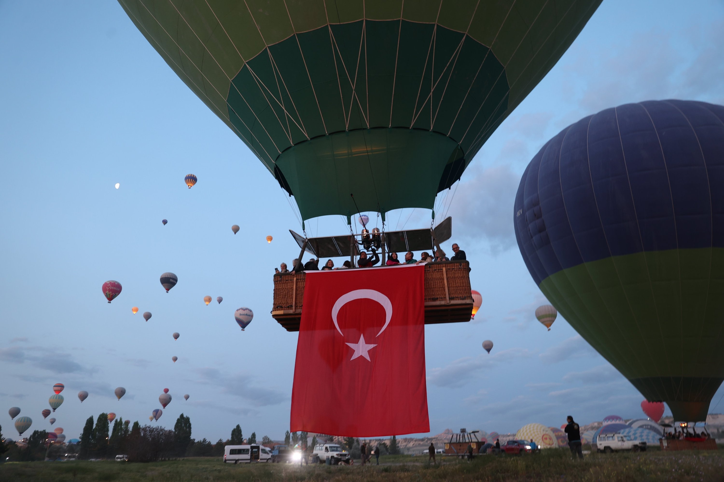 Hot air balloons fly over Cappadocia, displaying Turkish flags and Atatürk portraits to mark the May 19 Commemoration of Atatürk, Youth and Sports Day, Cappadocia, Türkiye, May 19, 2025. (AA Photo)