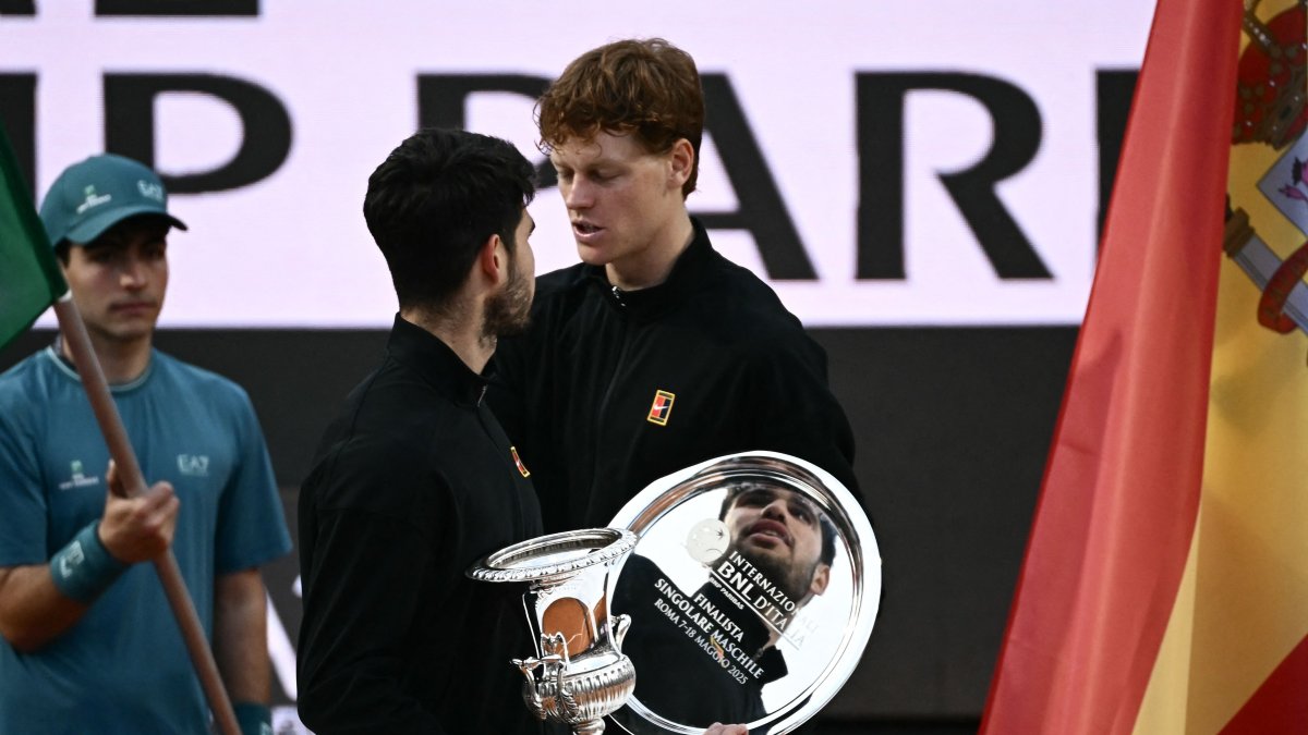 Spain&#039;s Carlos Alcaraz and Italy&#039;s Jannik Sinner talk on the podium at the end of their men&#039;s singles final match at the ATP Rome Open at Foro Italico, Rome, Italy, May 18, 2025. (AFP Photo)