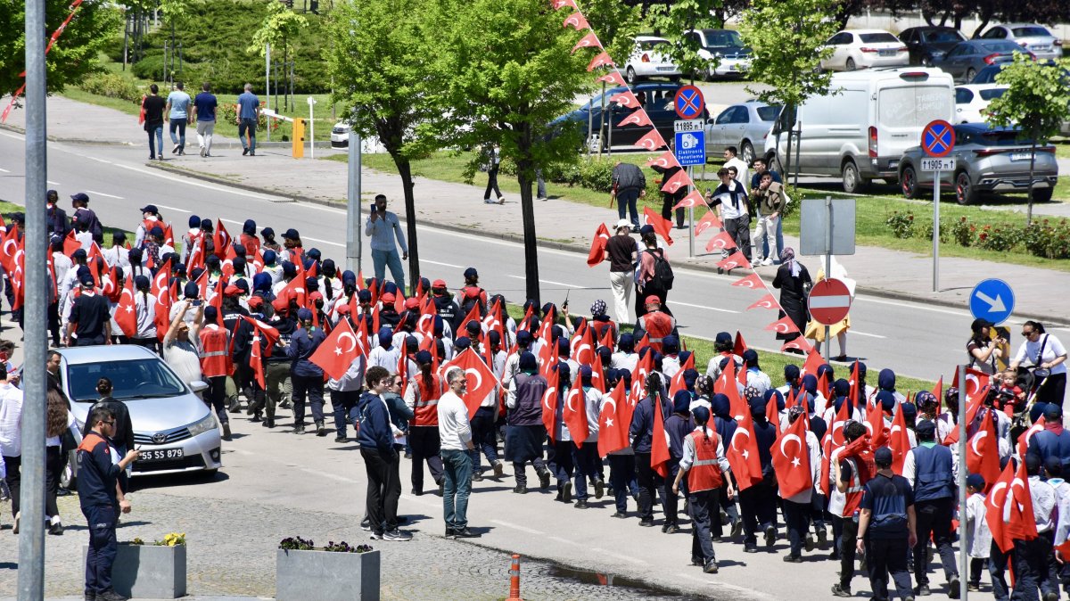 A Turkish flag representing Atatürk is carried by scouts in a procession from Tobacco Pier to the Athletics Stadium, Samsun, Türkiye, May 19, 2025. (AA Photo)
