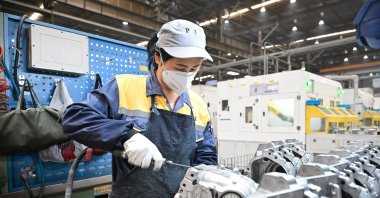 An employee works at a factory which produces car parts in Suzhou, Jiangsu province, China, May 15, 2025. (AFP Photo)