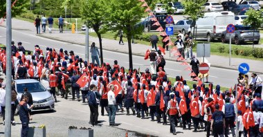 A Turkish flag representing Atatürk is carried by scouts in a procession from Tobacco Pier to the Athletics Stadium, Samsun, Türkiye, May 19, 2025. (AA Photo)